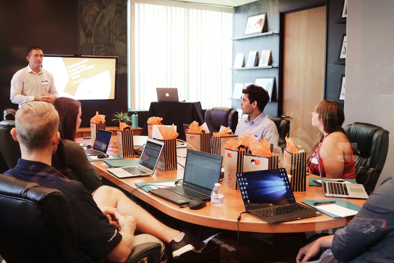 Speaker presenting slides to a meeting room